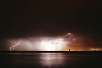 Scenic view of sea against sky at night