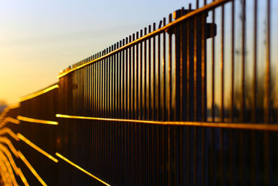 Train on railroad track against sky during sunset