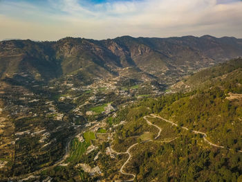 High angle view of land and mountains against sky