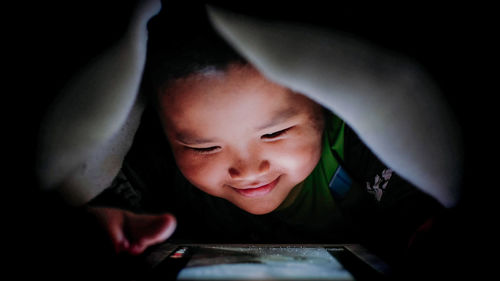Portrait of boy looking through mobile phone