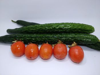 High angle view of fruits in plate against white background