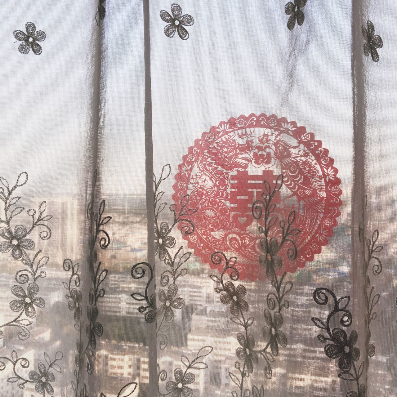 DIGITAL COMPOSITE IMAGE OF GLASS WINDOW WITH RED FLOWERS