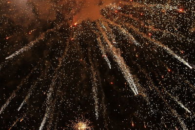 Low angle view of firework display at night