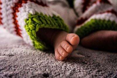 Low section of baby feet on rug