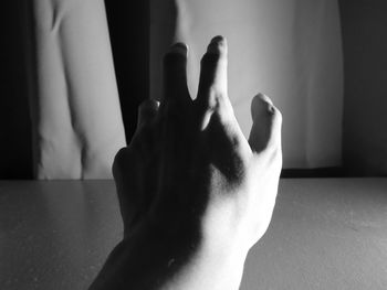 Close-up of cropped hand gesturing at home