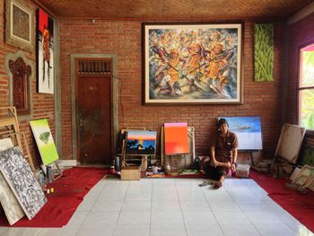 Rear view of woman sitting on floor