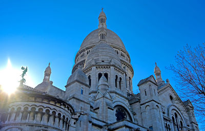 Low angle view of historical building against blue sky