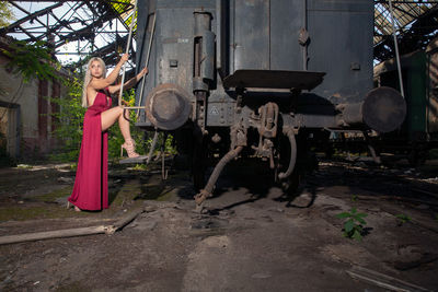 Young woman standing in abandoned shunting yard