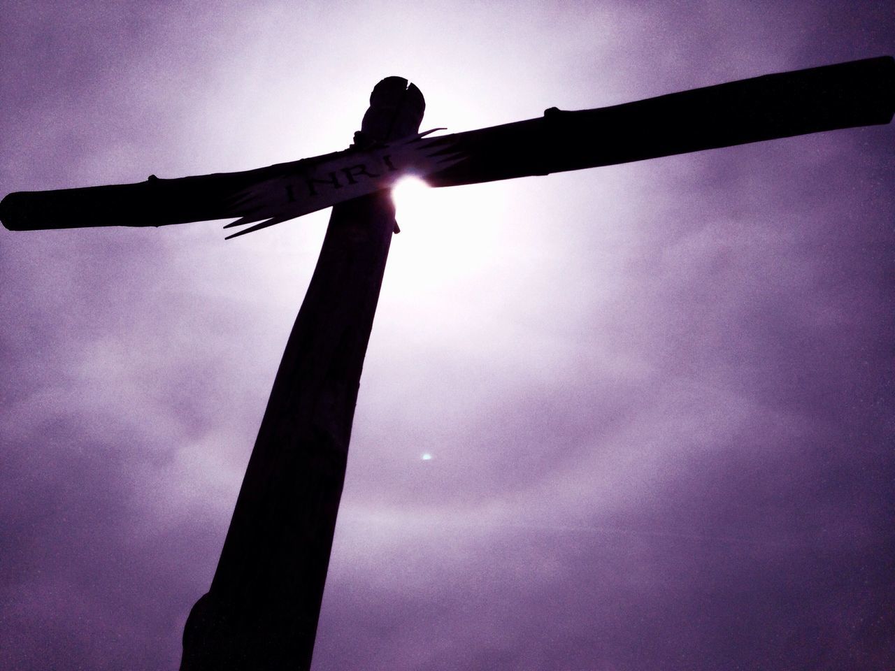 low angle view, sky, silhouette, sun, outdoors, dusk, no people, cloud - sky, sunset, lens flare, sunlight, sunbeam, nature, day, cloud, bird, back lit, built structure, metal, renewable energy