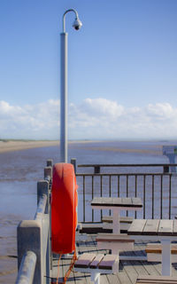 Empty beach against blue sky and clouds