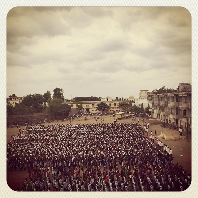 transfer print, large group of people, auto post production filter, sky, crowd, built structure, architecture, building exterior, cloud - sky, abundance, crowded, cloudy, mixed age range, person, day, lifestyles, high angle view, cloud, large group of objects