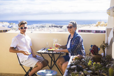 Grandmother and grandson having food at restaurant