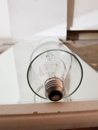 Close-up of light bulb on table