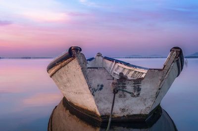 Boat moored on sea against sky