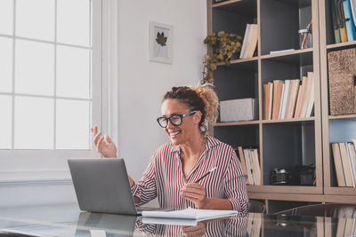 Young businesswoman using laptop at office