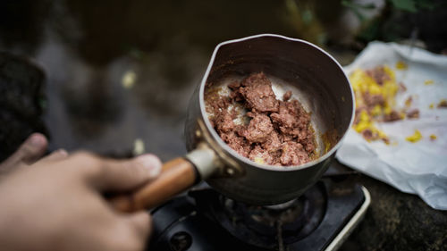 Cropped hand of person preparing food