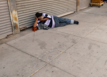 Man sleeping on sidewalk