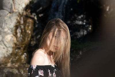 Close-up portrait of young woman standing outdoors