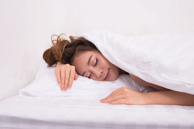 Young woman sleeping in bed