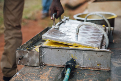 Cropped man with machinery at table