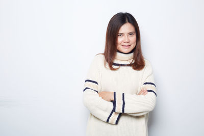 Portrait of a smiling young woman over white background