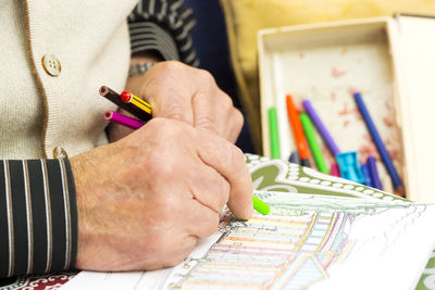 Midsection of person making drawing on paper