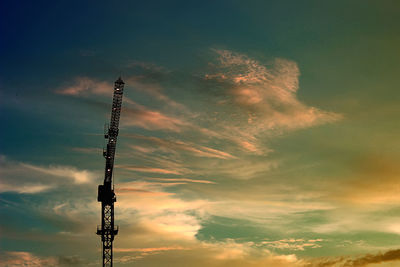 Low angle view of silhouette crane against sky during sunset