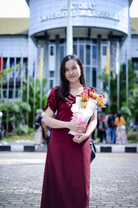 Portrait of young woman holding gift