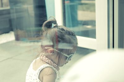 Portrait of woman in glass window