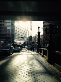 Traffic on road amidst buildings in city