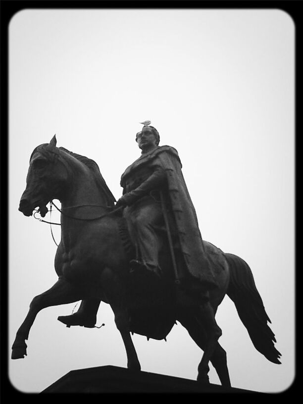 transfer print, low angle view, auto post production filter, clear sky, statue, sculpture, human representation, silhouette, copy space, art and craft, sky, creativity, bird, art, outdoors, day, full length, men, horse