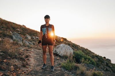 Full length of woman standing on mountain