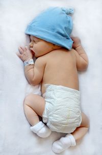 Close-up of baby girl sleeping in bed