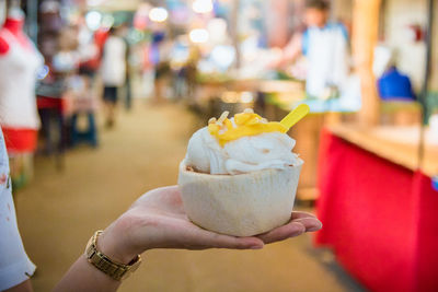 Close-up of hand holding ice cream cone