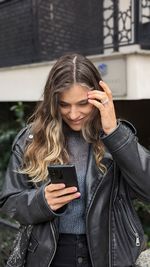 Young woman using mobile phone