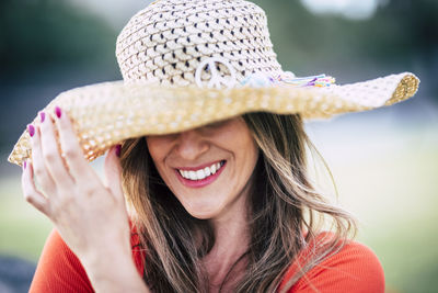 Close-up of smiling woman wearing hat