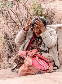 Portrait of a man sitting outdoors