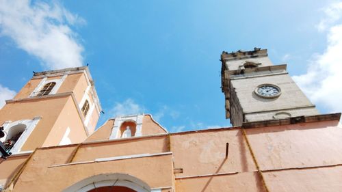 Low angle view of bell tower against blue sky