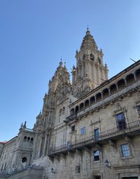 Low angle view of historical building against clear blue sky