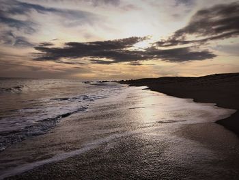 Scenic view of beach against sky during sunset