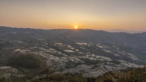 Scenic view of mountains against sky during sunset