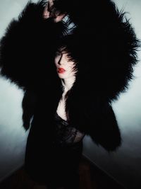 Portrait of young woman wearing fur hat