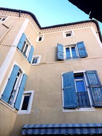 Low angle view of building against blue sky