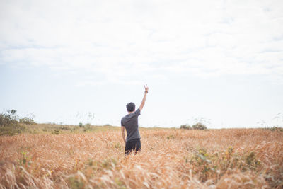 Full length of woman standing on grassy field