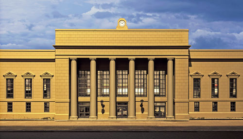 Low angle view of building against cloudy sky