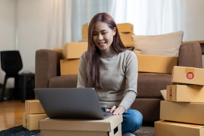 Young woman using laptop at home