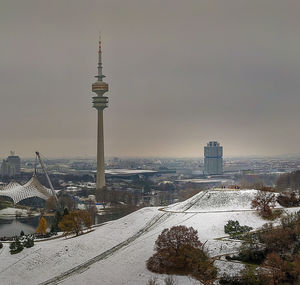 Tower and buildings in city during winter