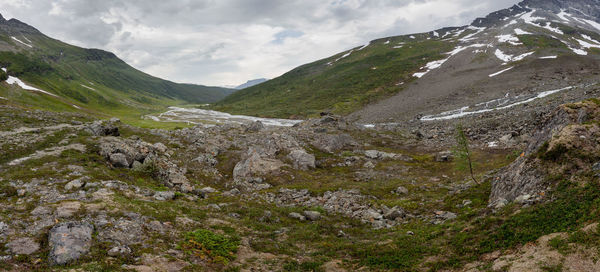 Panoramic shot of mountains against sky during winter