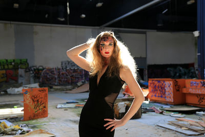 Portrait of beautiful fashion model standing in abandoned building