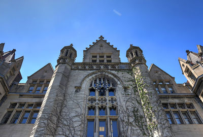 Low angle view of building against blue sky